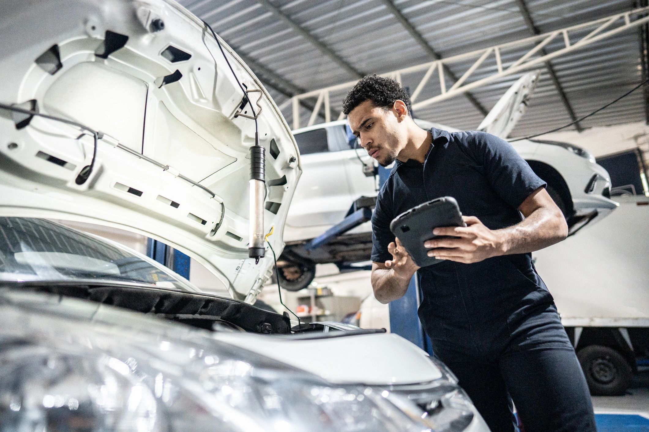 Technician performing brake service in a repair shop