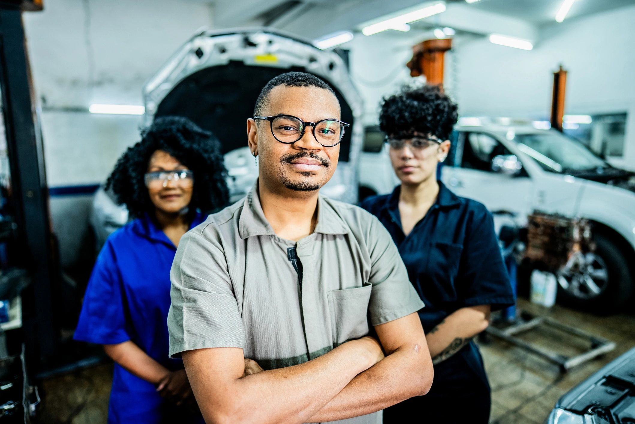 Mechanic with coworkers in an auto repair shop