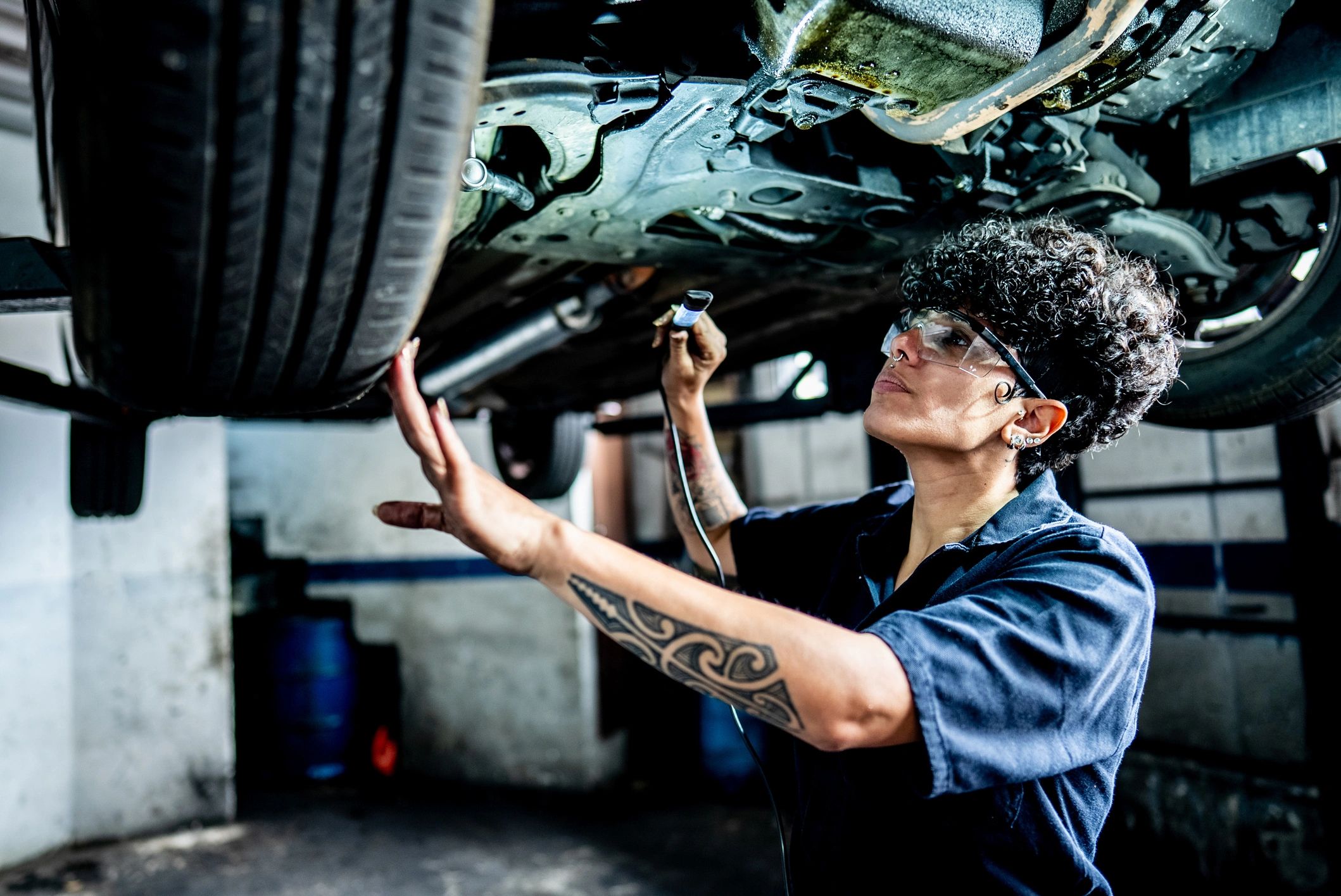 Mechanic inspecting a vehicle brake in an auto repair shop