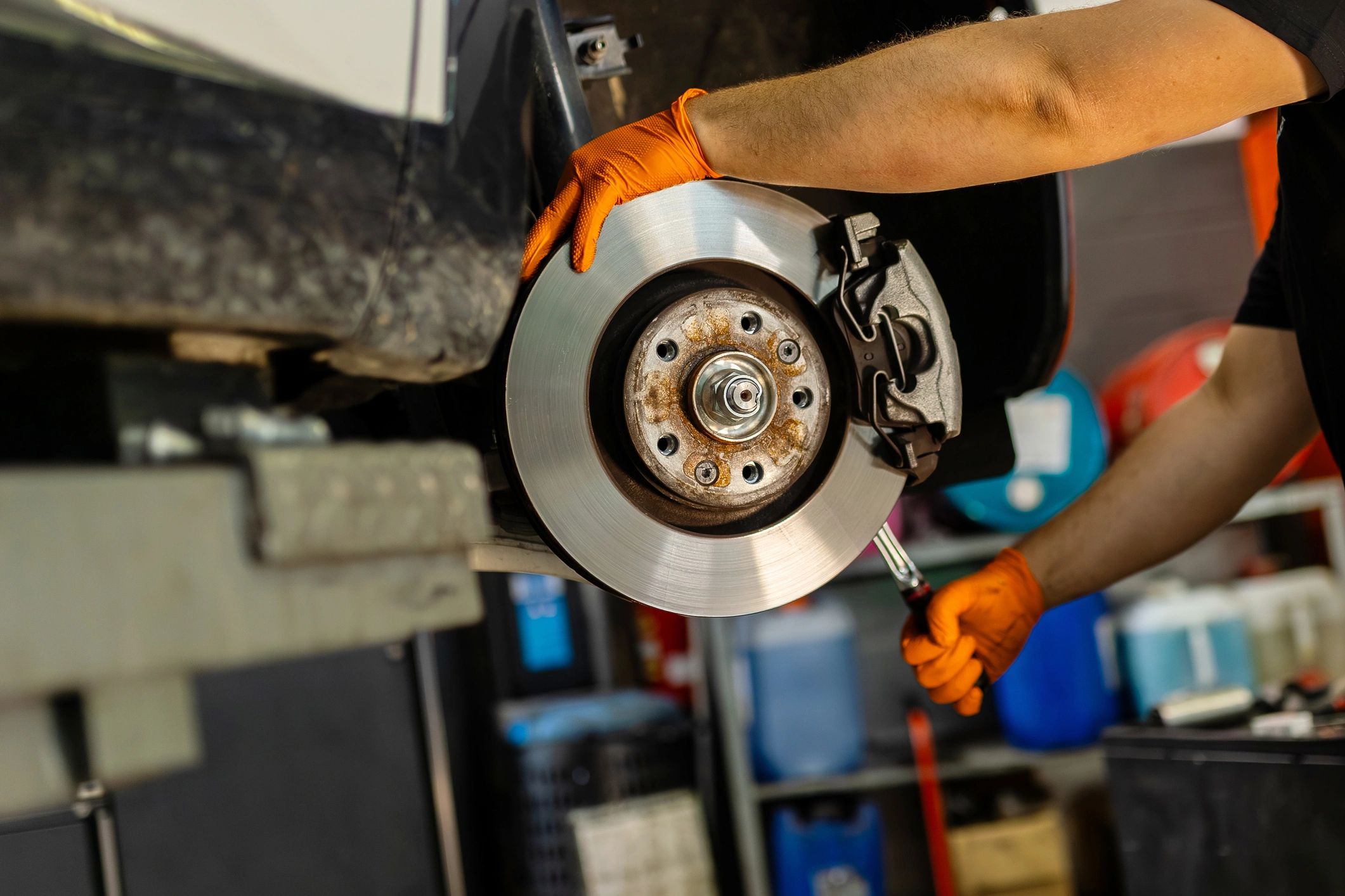 Mechanic inspecting a brake rotor in an auto workshop