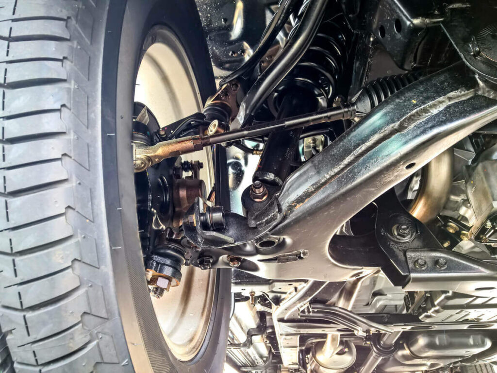 Close-up of a vehicle's suspension and wheel assembly.